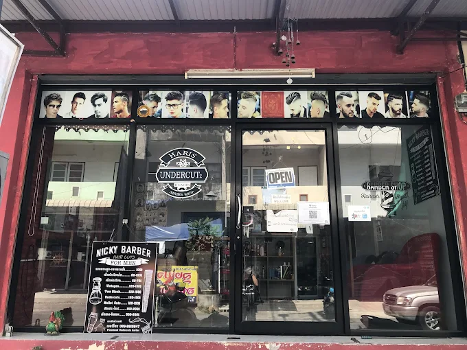 Storefront of Undercutz Barbershop in Hua Hin with red exterior